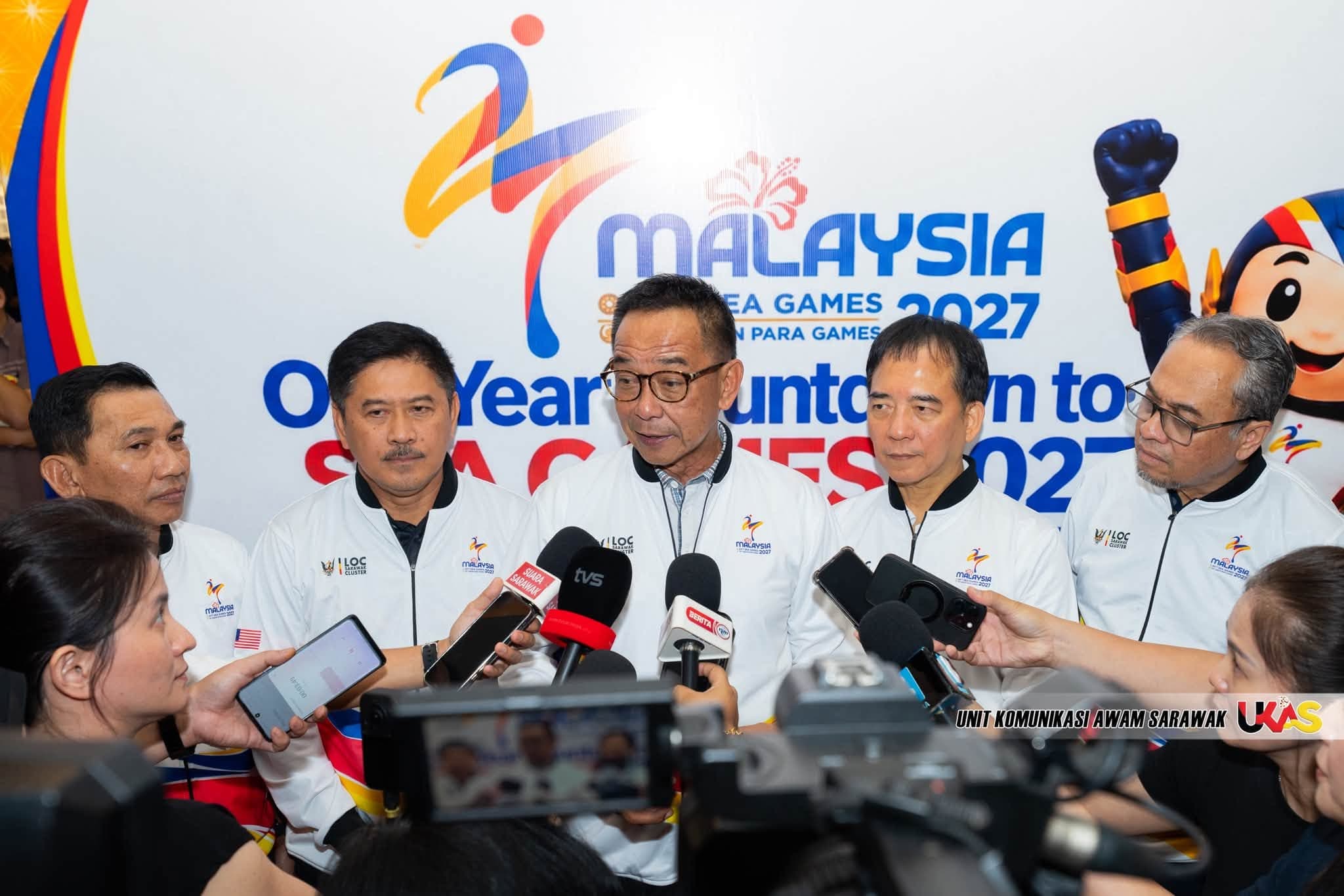 LOC Sarawak officials take press questions in front of the One Year Countdown to SEA Games 2027 wall, with TUAH beside the lockup.