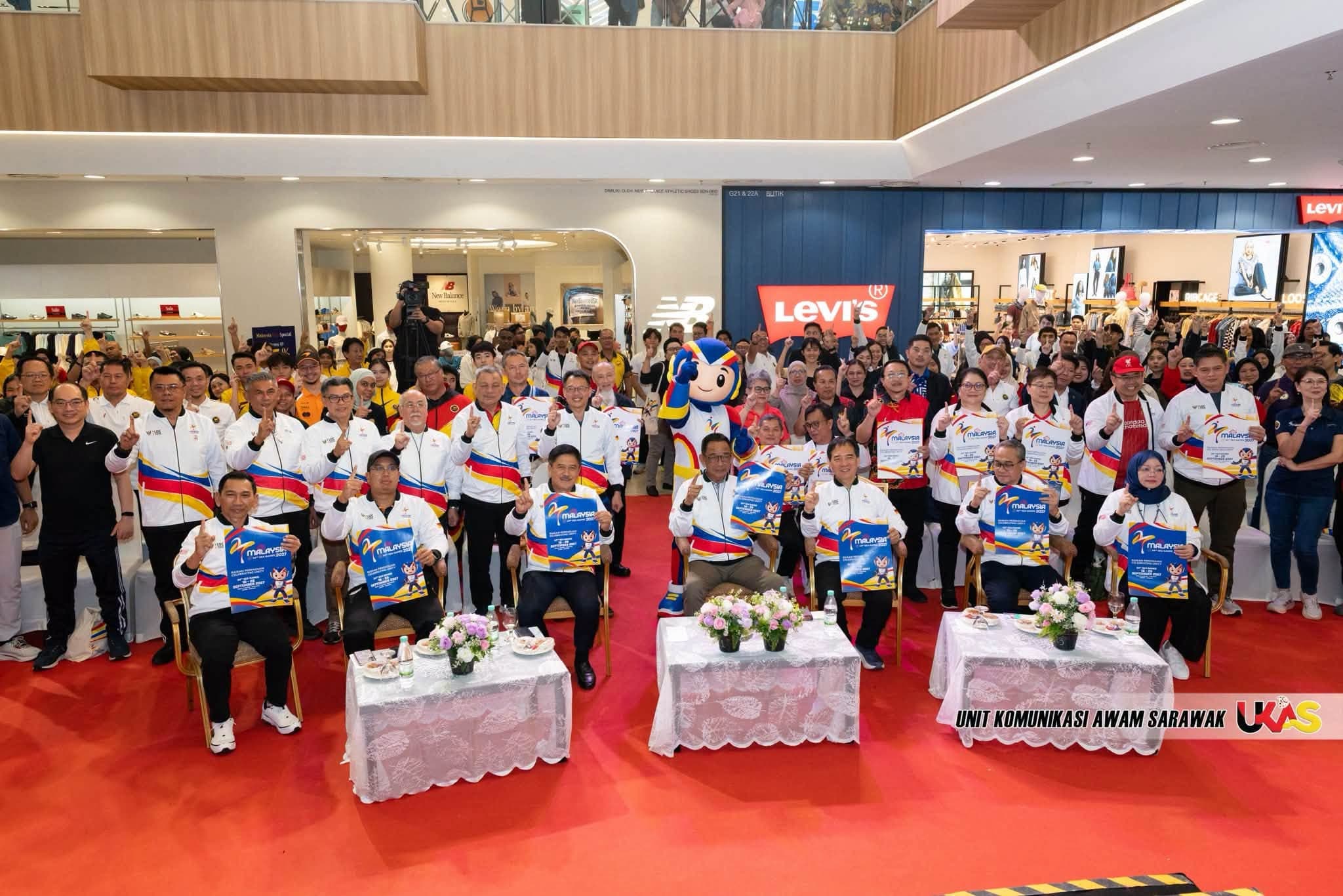 A mall gathering with TUAH and officials holding Malaysia 2027 posters.