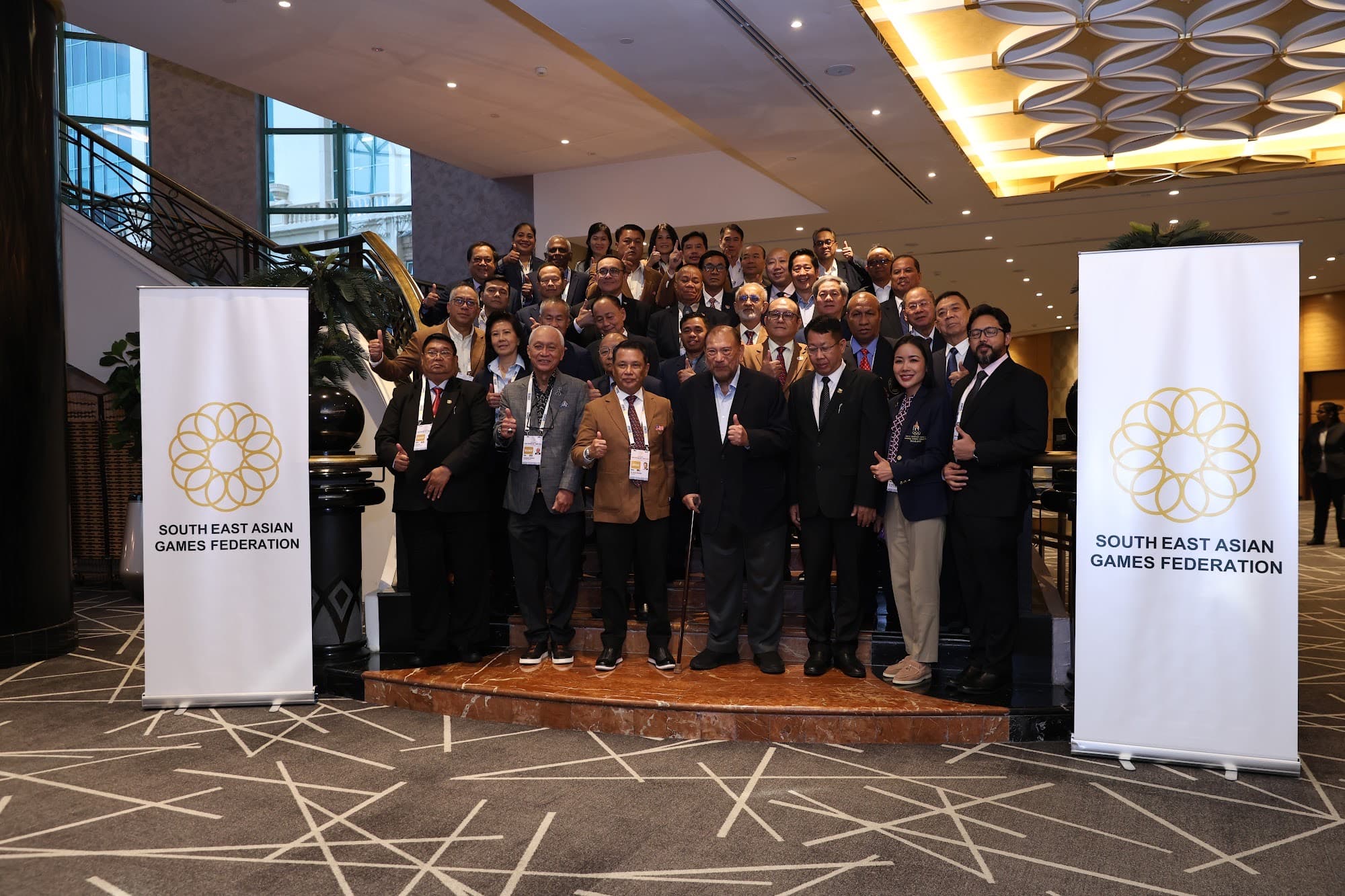 SEAGF delegates in a group photograph between South East Asian Games Federation banners.
